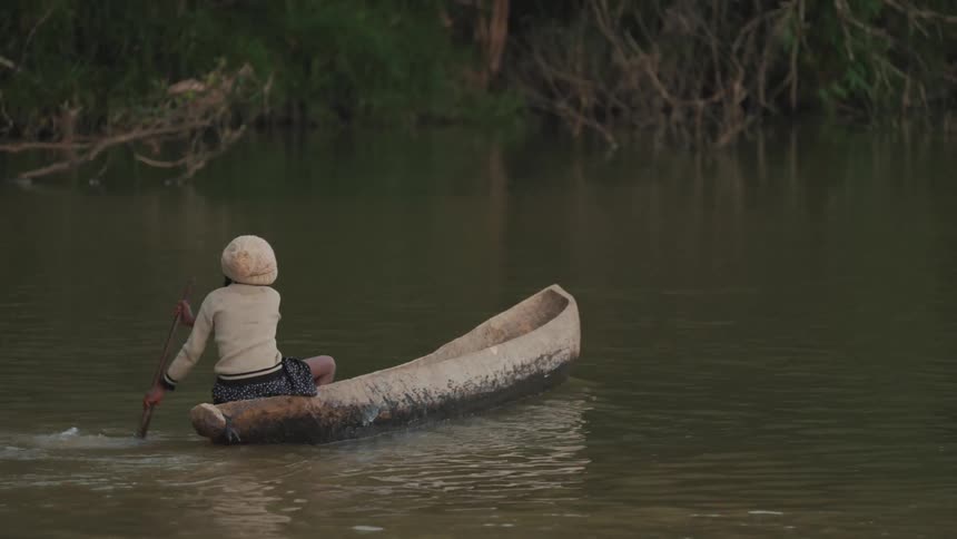 A person riding a canoe in a river