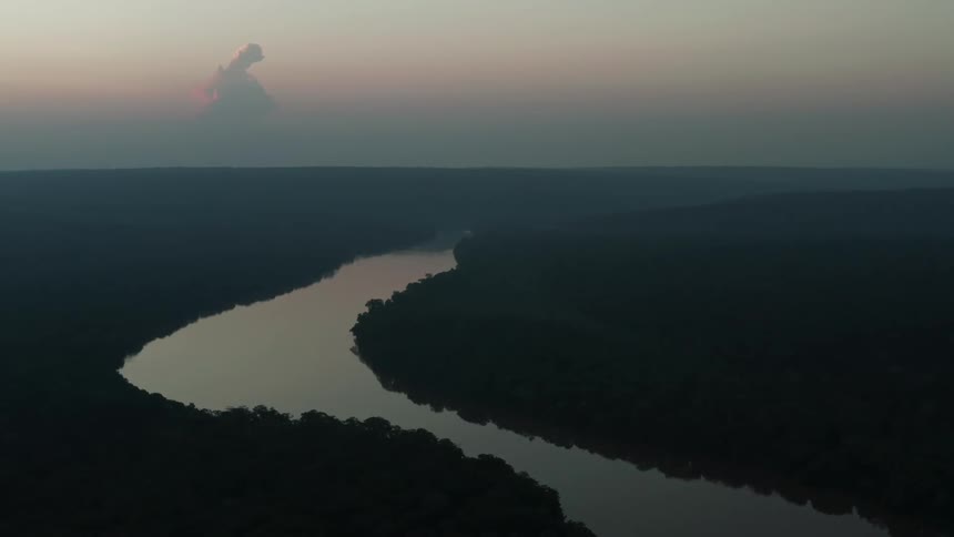 The sun is setting on the river