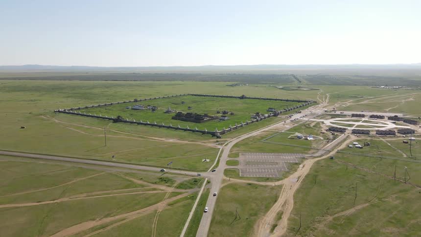 An aerial clip of a vast grass land with few structures and freeway