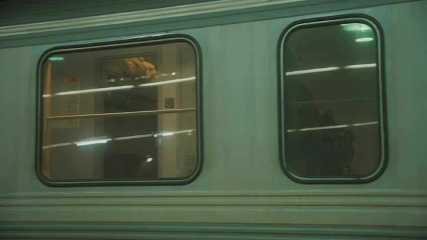 Man walking inside the train with a backpack on his back