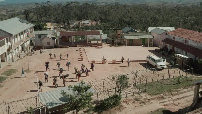 A small town with people carrying loads on their head