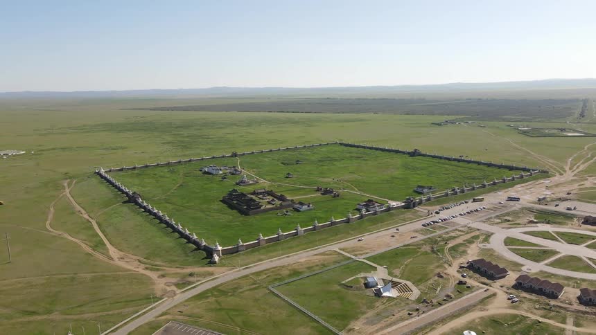 A farm with fences and a green lawn