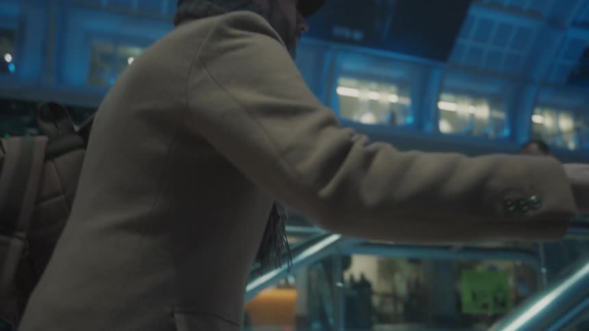 A man on the escalator in a terminal
