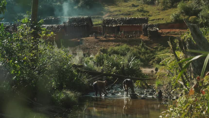 People from a small village wash clothes in a lake