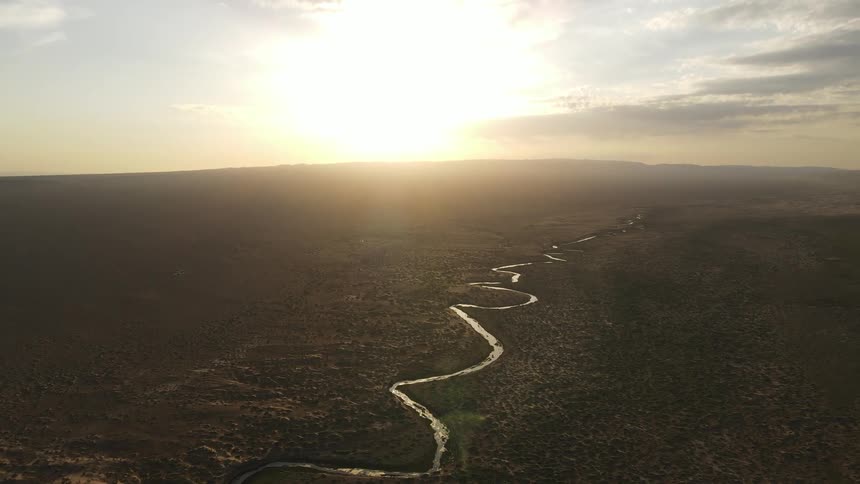 A curved river across a large plain