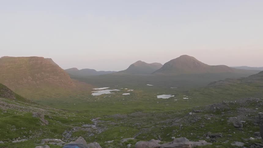 Landscape of a mountain range amid small lakes in the morning