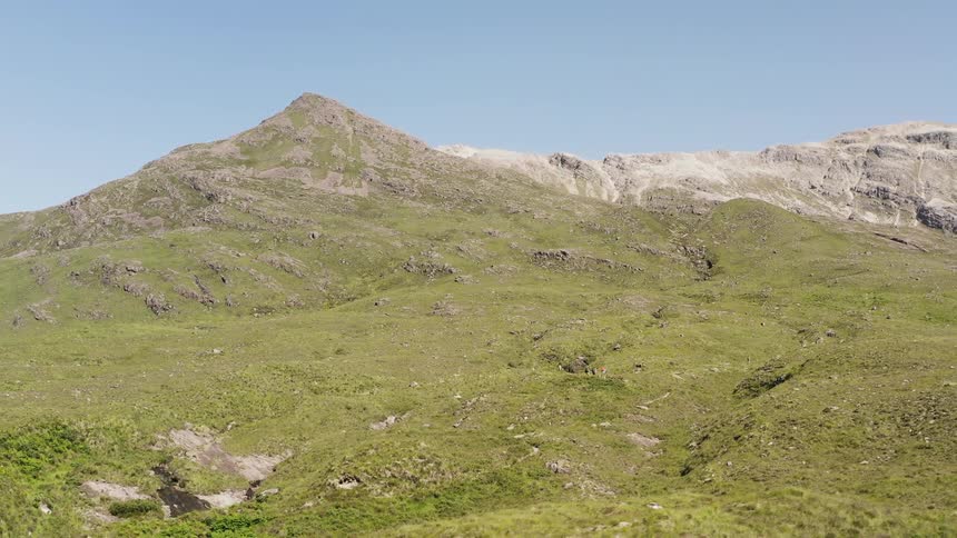 Aerial panorama of mountain peaks covered in moss on a cloudless day