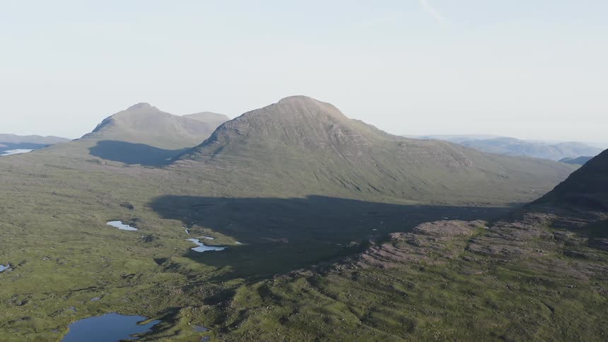 Aerial view of small lakes in the valley next to the mountains