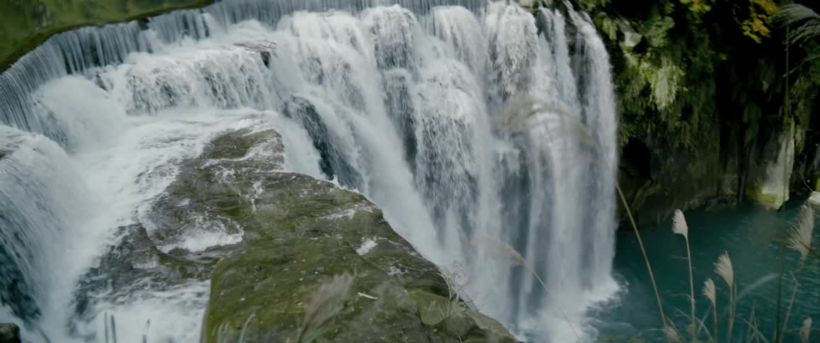 A waterfall from the stream of a river in the rain forest