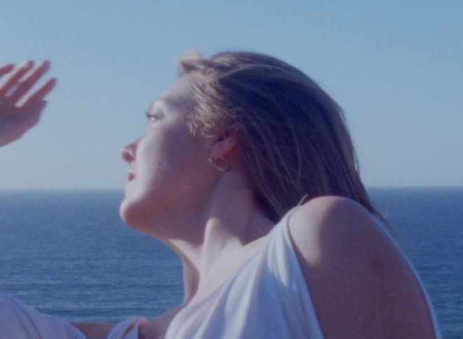 Close up of a woman dancing next to the ocean