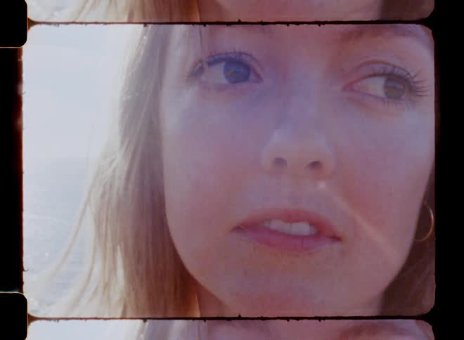 The face of a female in front of the ocean