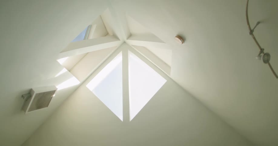 A window is set into the corner of two walls and the ceiling