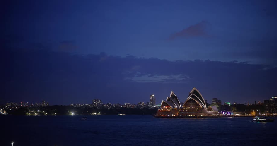 View of the sydney opera house at night by the waterfront