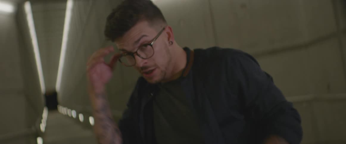 A man while dancing removes his glasses briefly