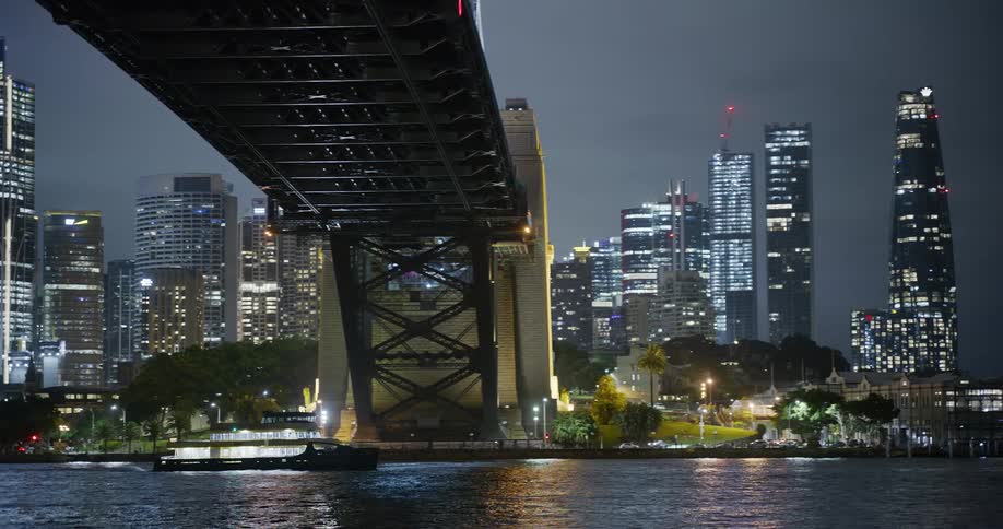 A ferry passes under the bridge