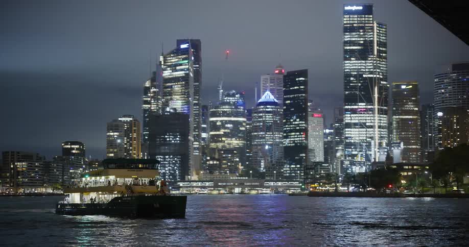 A ferry passes under the bridge