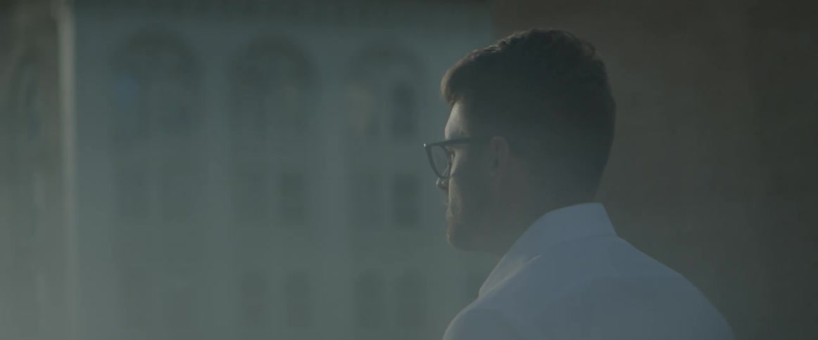 Man stands outside and turns his head