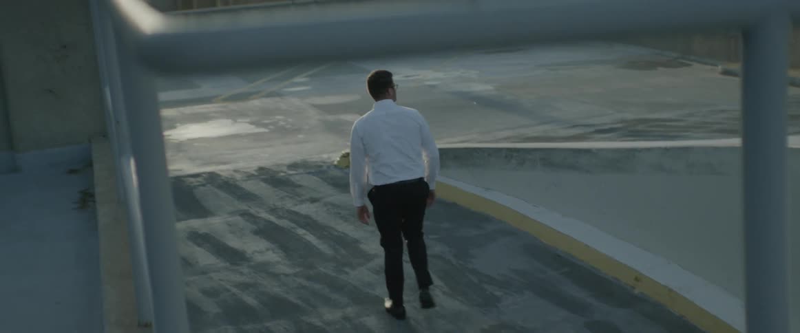 A man walks up to the top of a parking garage