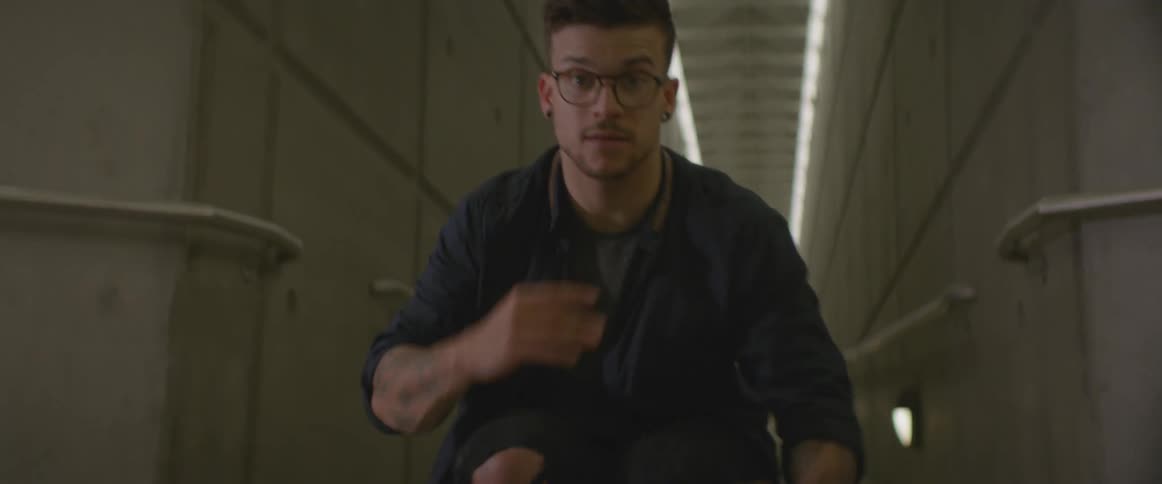 A man is dancing in a tunnel
