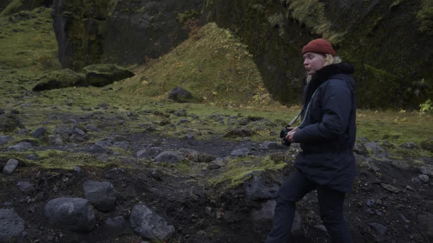 A photographer climbs over the rocks