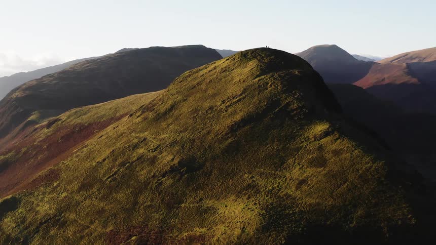 Aerial view of people standing atop a mountain