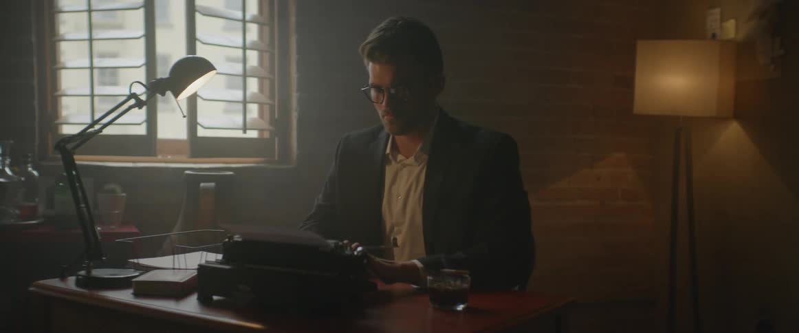 A man is typing on a typewriter in an office
