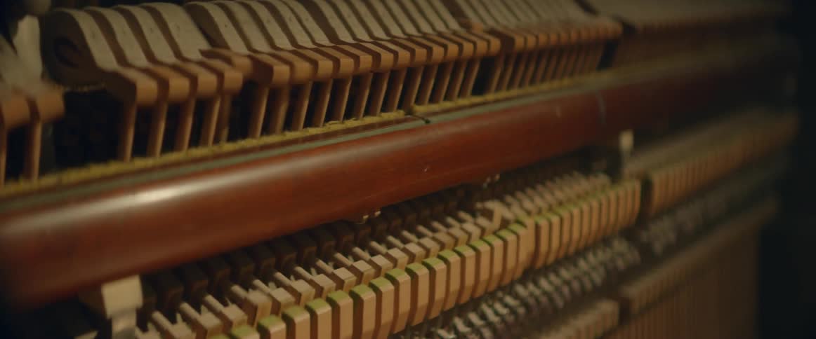 A piano is played as strikers trigger the keys