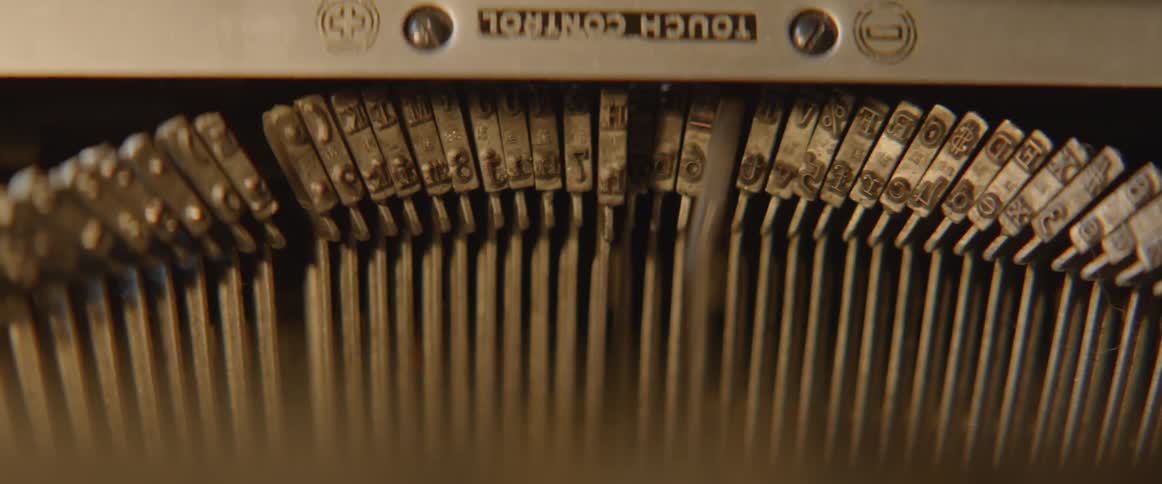 The inside of a typewriter as someone uses it