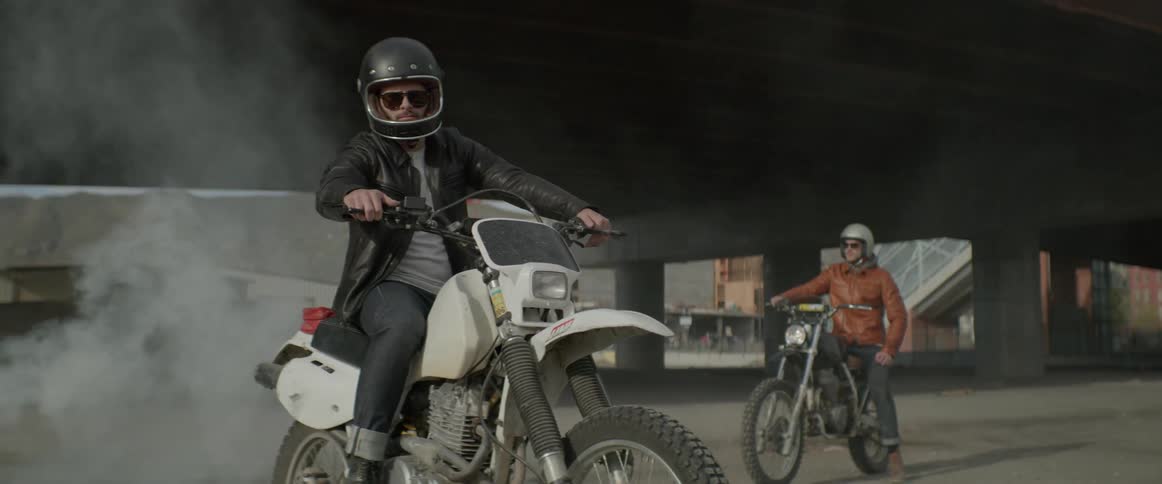 A man sits on a motorcycle revving the engine