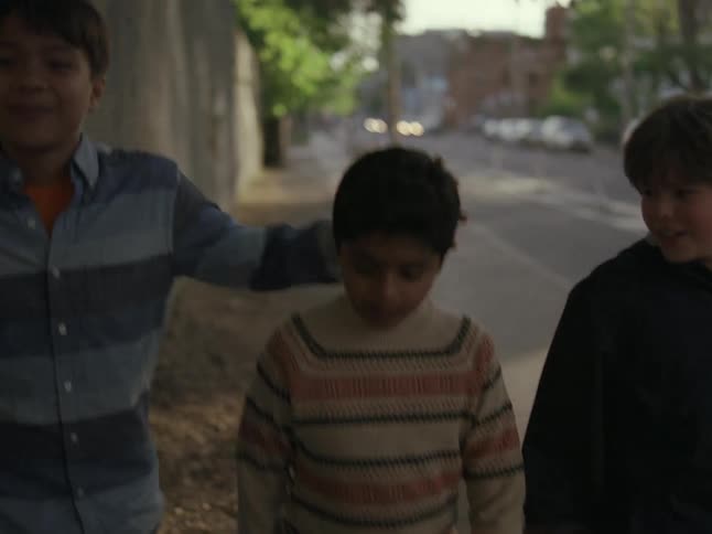 Three friends walk down the street