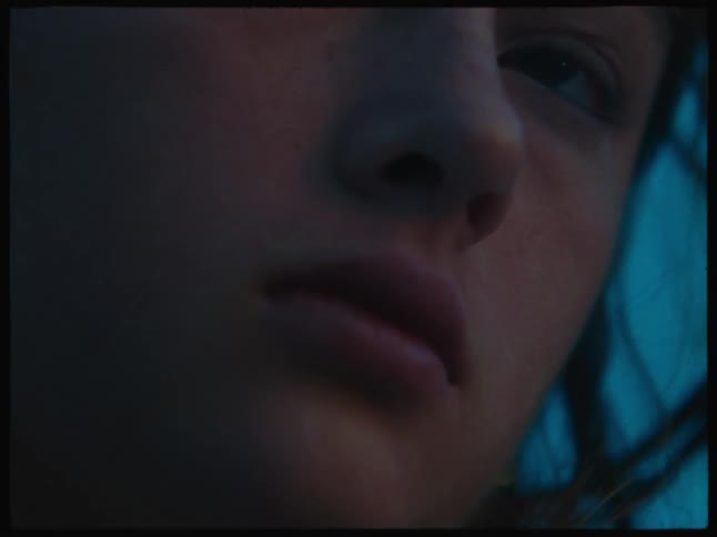 A face of a woman and she turn her head to her right