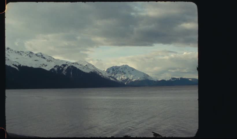 Lake next to snowy mountains at morning