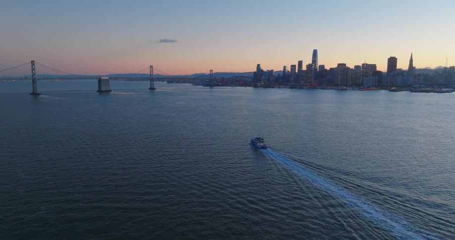 A boat sailing towards a large city