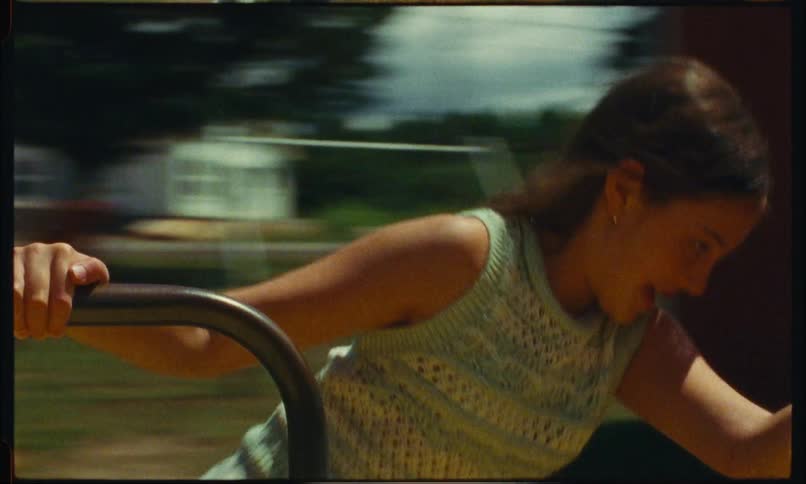 Portrait of a young girl spinning a toy on an outdoor playground