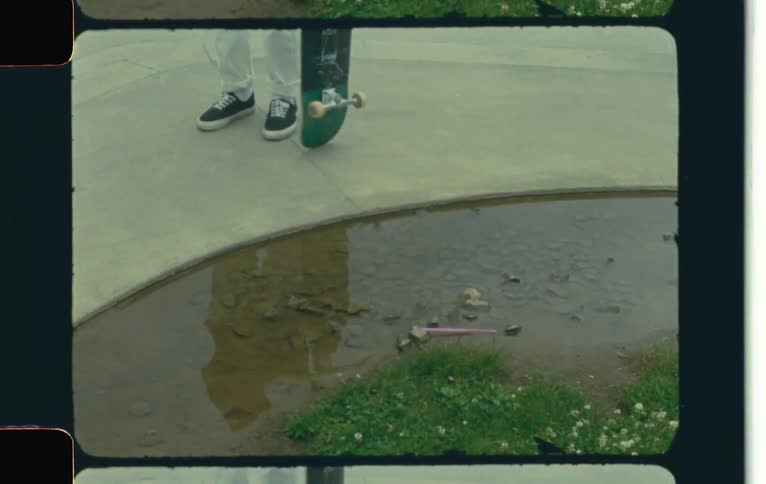 A person spinning a skateboard in a courtyard