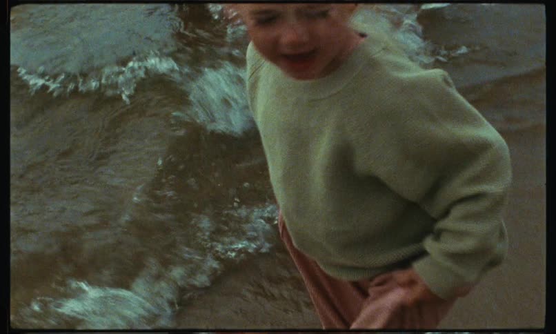 Girl gets her feet wet on beach