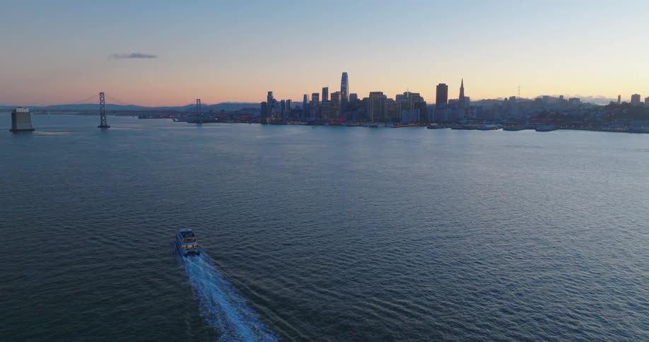 Ferry near the skyline of san francisco at sunset