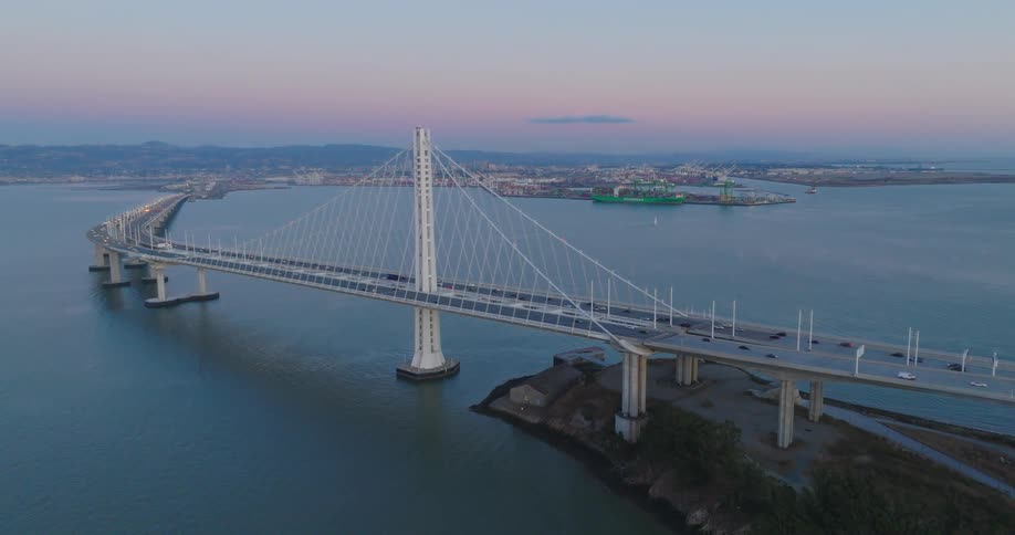 Aerial panorama of a bridge over the sea with vehicle traffic on a morning