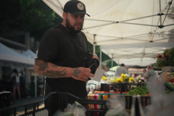 A man is shopping at a farmers market