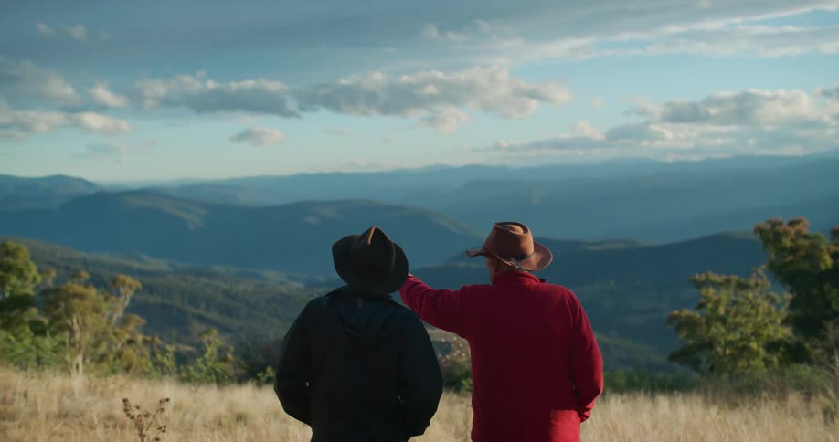 A clip of two old men having a conversation on a vast land area