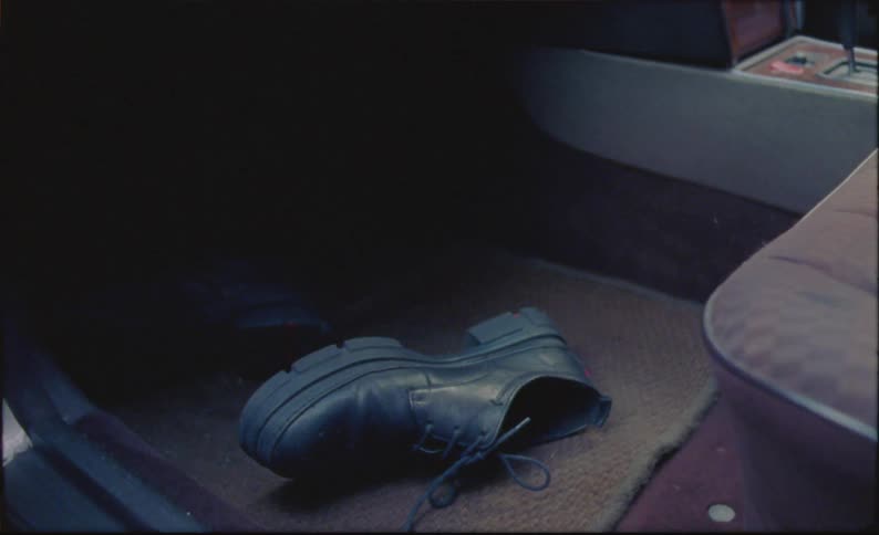 Close up of shoes on the floor of a car