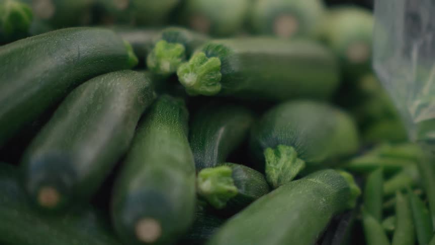 Several cucumbers overlapping in a grocery store