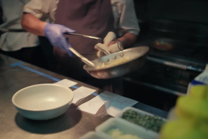 A chef preparing a meal in a restaurant