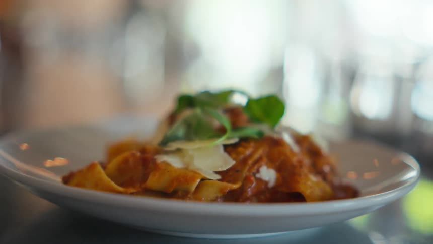 A small serving of a pasta dish with elaborate presentation