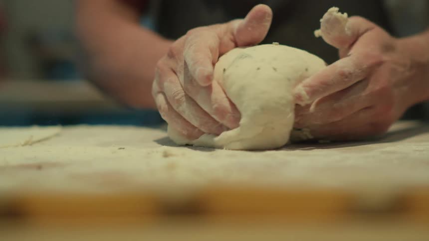 A person is kneading dough