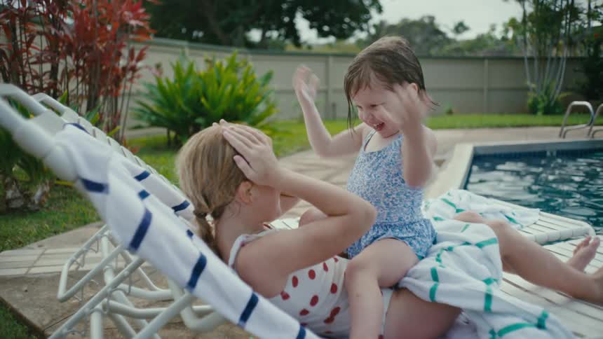 Sisters playing in the backyard pool