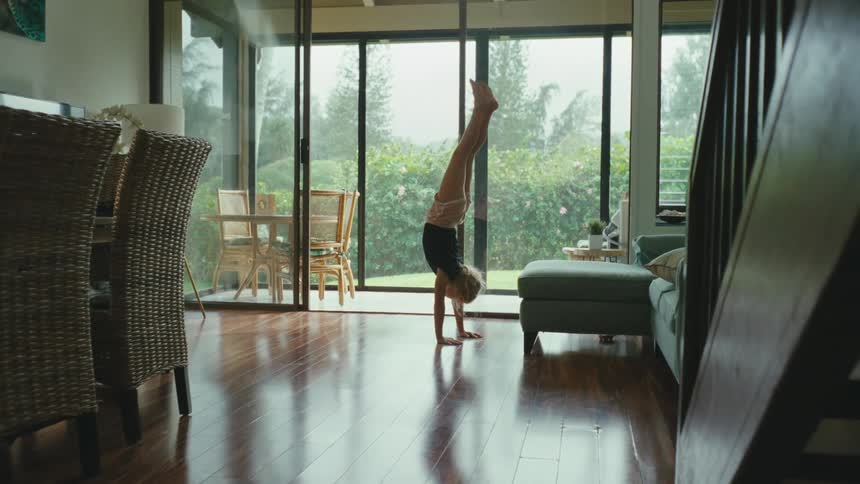 A clip of a kid playing aerobic in the living room