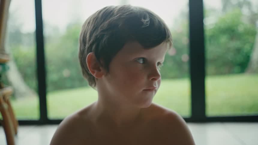 A child is looking around in the room