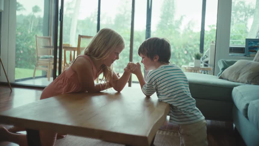 Two children are arm wrestling