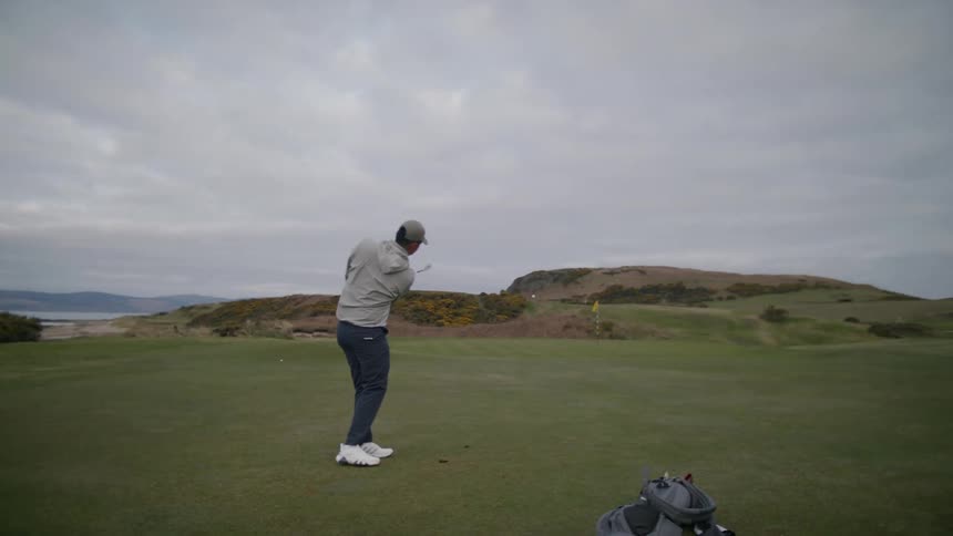 A man hits the golf ball